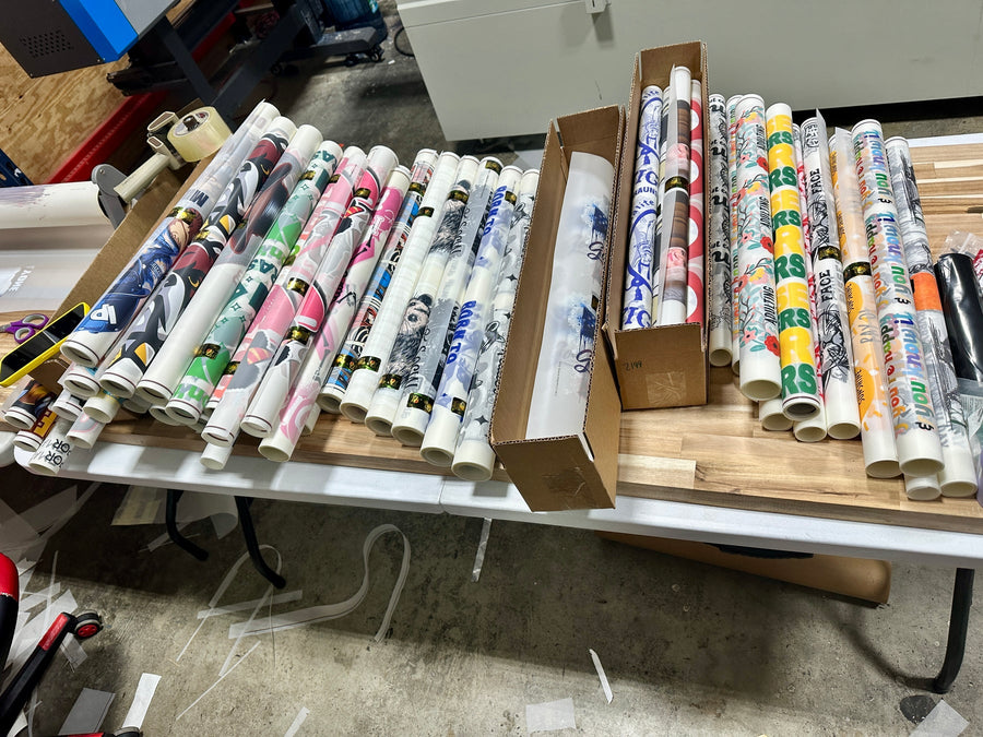 Printed transfer rolls on the Buy Bulk DTF production worktable